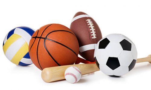 This is a photo of a variety of balls and sporting equipment isolated on a white background.